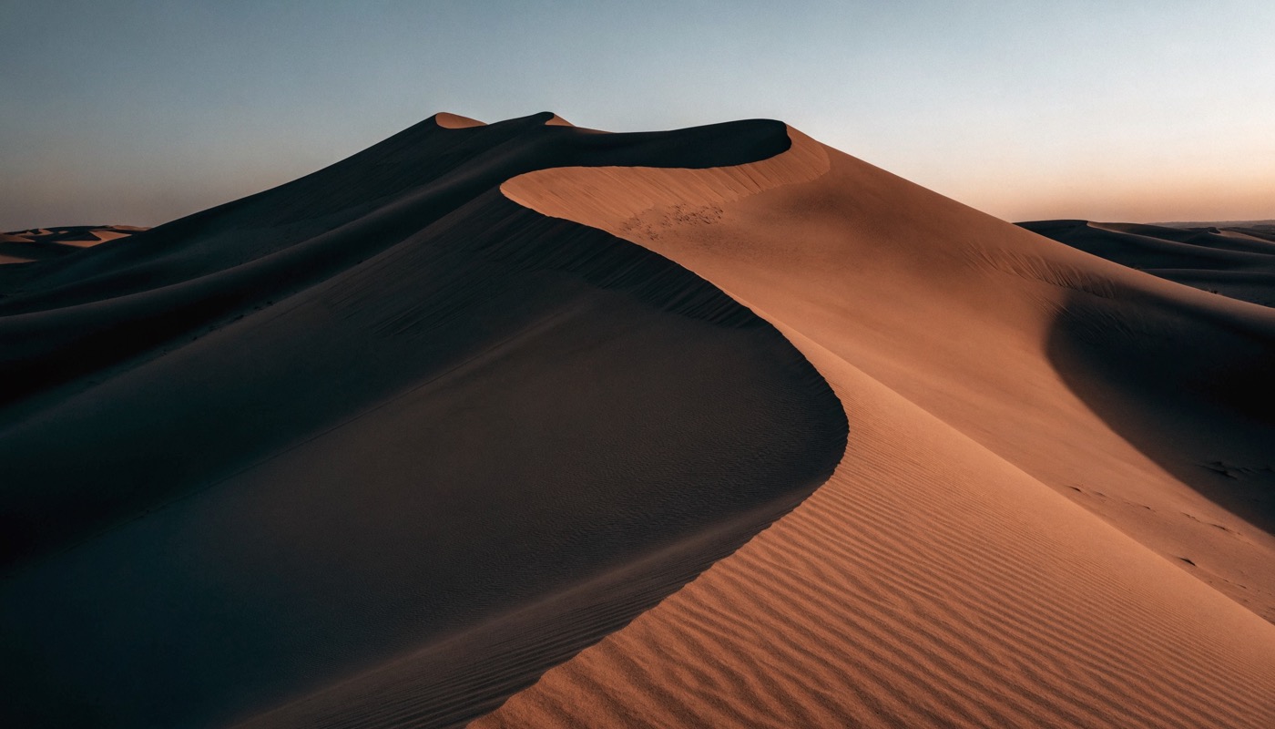 Photographic image of desert dunes at last light